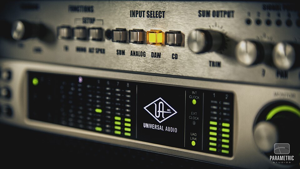The front of a Universal Audio Apollo rack interface with its meters lit.