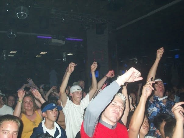 The crowd with their arms in the air.