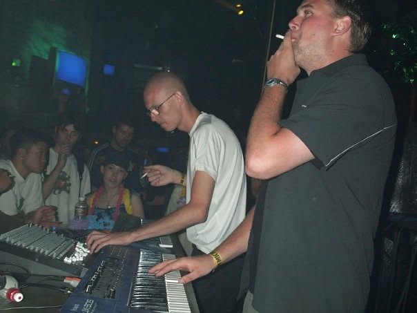 At the mixer and keyboards with the audience close around.