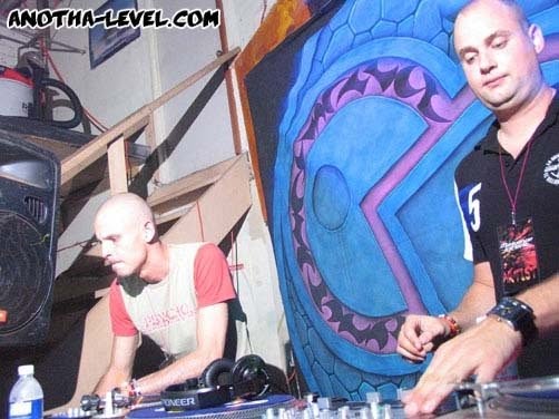 At the decks in front of a painted blue and red wall.