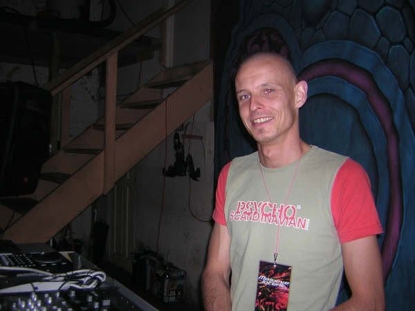 Smiling by the stage with an artist pass.