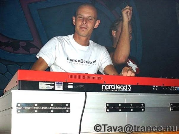 Playing a red Nord Lead 3 on stage in a trance[]control T-shirt.