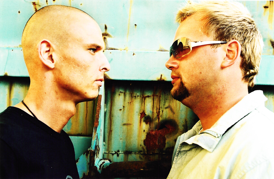 The two in profile, face to face, in front of the container.