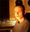 DjC in the studio DjC in the studio, his face lit in orange from below.